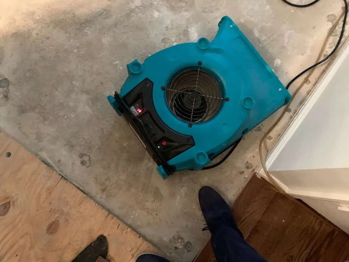 Air mover drying subfloor during Leak Detection & Repair in Owasso